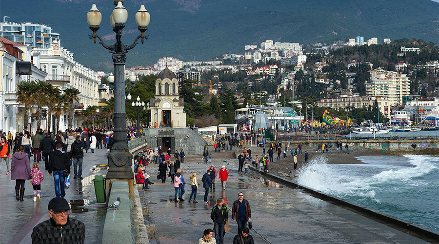Click to enlarge Pedestrians on an embankment in Yalta in January.