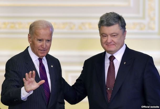 U.S. Vice President Joe Biden (left) waves after a joint press conference with Ukrainian President Petro Poroshenko in Kyiv on January 16