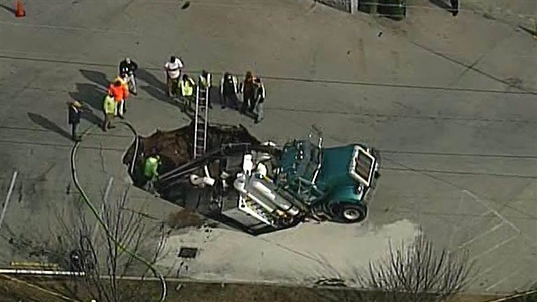 Excavation truck falls into sinkhole