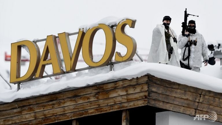 Swiss special police forces take position next to a sign reading Davos