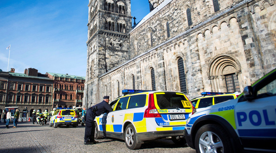 Click to enlarge Policeman next to police vehicle
