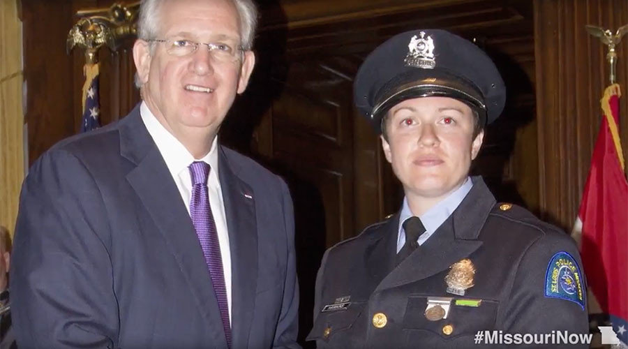 Missouri Governor Jay Nixon (L) and St. Louis police officer Angela Hawkins (R)