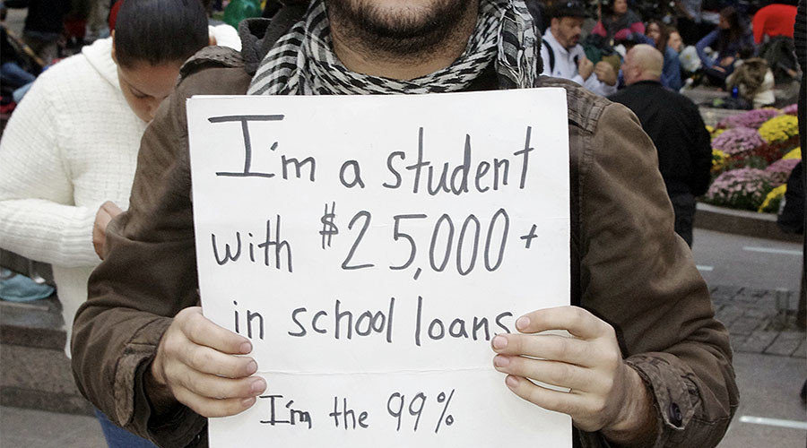 Student holding debt sign