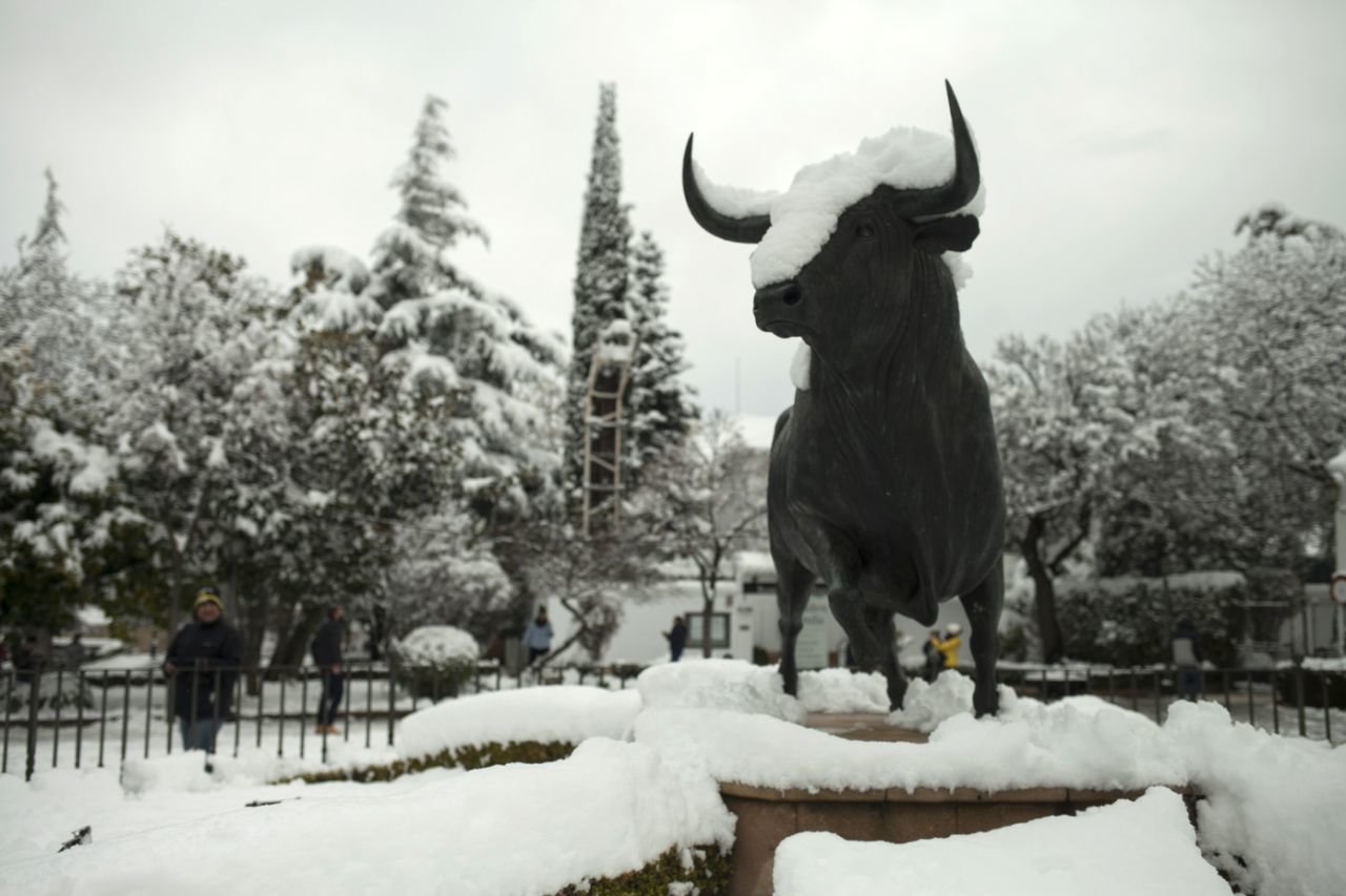 A statue of a bull is covered by snow at the entrance of the bullring in Ronda, southern Spain, Thursday, Jan. 19, 2017.