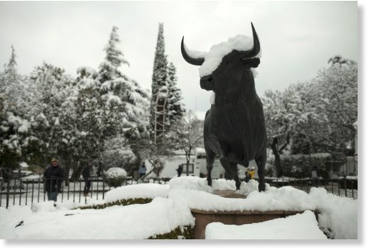 A statue of a bull is covered by snow at the entrance of the bullring in Ronda, southern Spain, Thursday, Jan. 19, 2017.