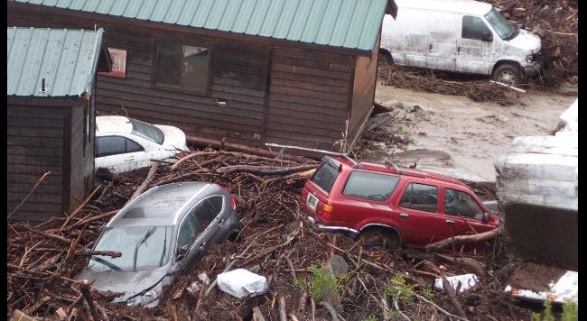 Displaced vehicles and cabins are seen near the creek at the flooded El Capitan Canyon Resort & Campground, Friday, Jan. 20, 2017. 