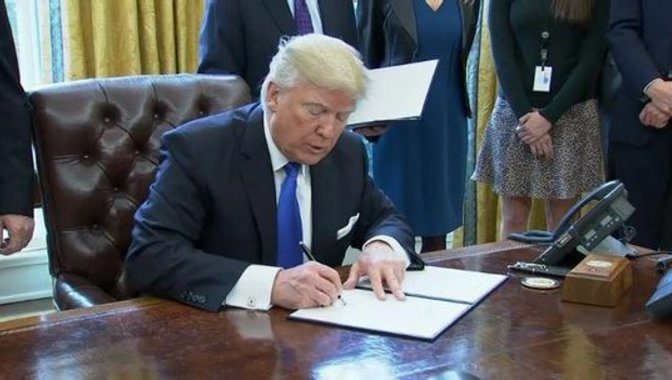 Click to enlarge Trump signing orders