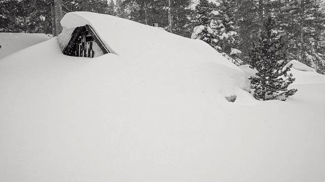 The top part of a structure peeks through the snow in Mammoth Lakes, which is experiencing a record-breaking month for snowfall.  