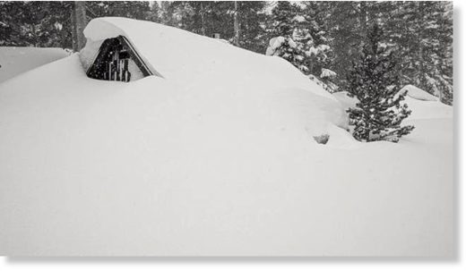 The top part of a structure peeks through the snow in Mammoth Lakes, which is experiencing a record-breaking month for snowfall.  