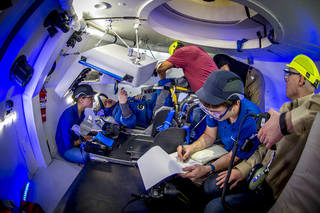 Astronaut Eric Boe evaluates Boeing Starliner spacesuit in mockup of spacecraft cockpit