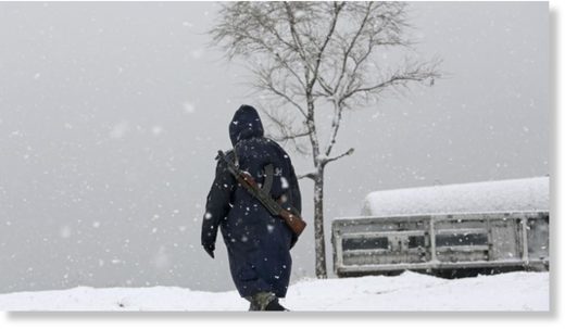 A security officer walks through snow on the Nadir Khan Hill in Kabul, Afghanistan.