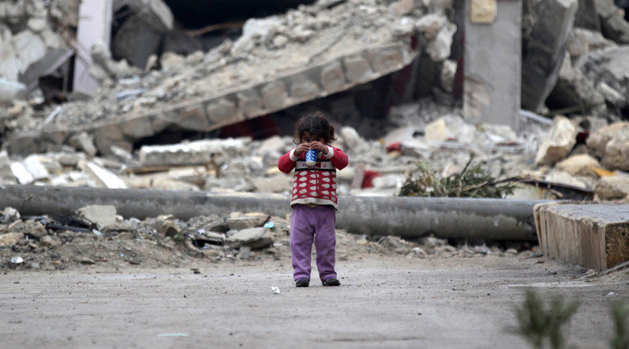  girl plays near rubble of damaged buildings in al-Rai town, northern Aleppo