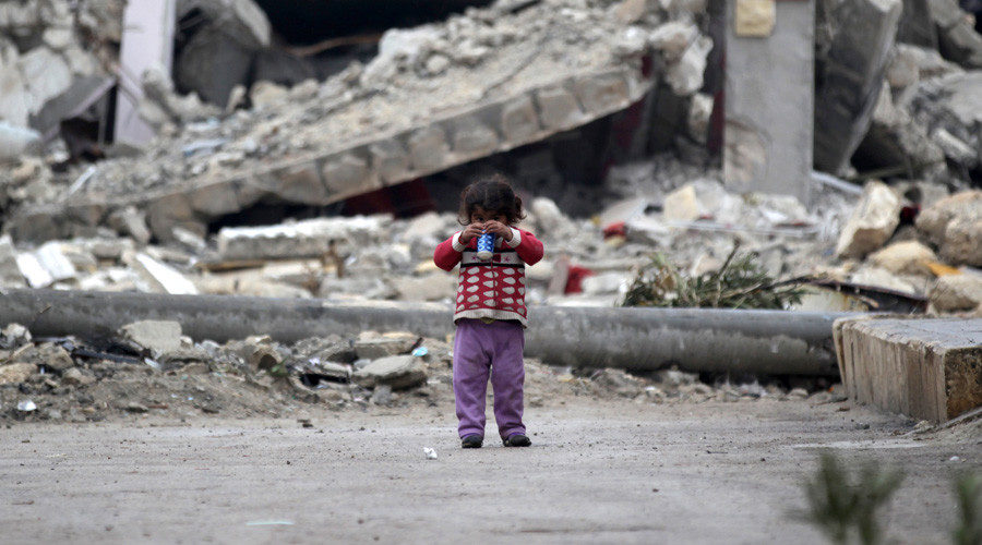 Click to enlarge girl plays near rubble of damaged buildings in al-Rai town, northern Aleppo
