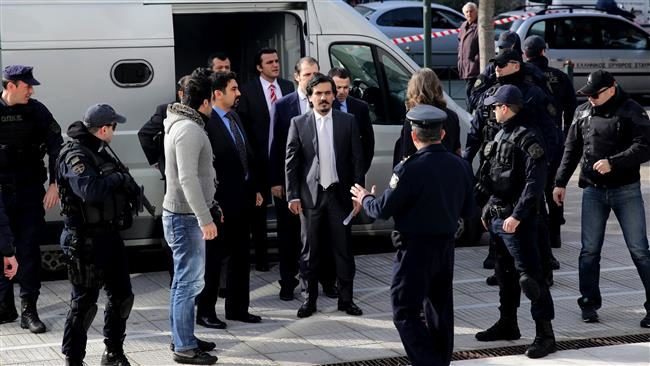 Click to enlarge Turkish officers are escorted by Greek special police forces