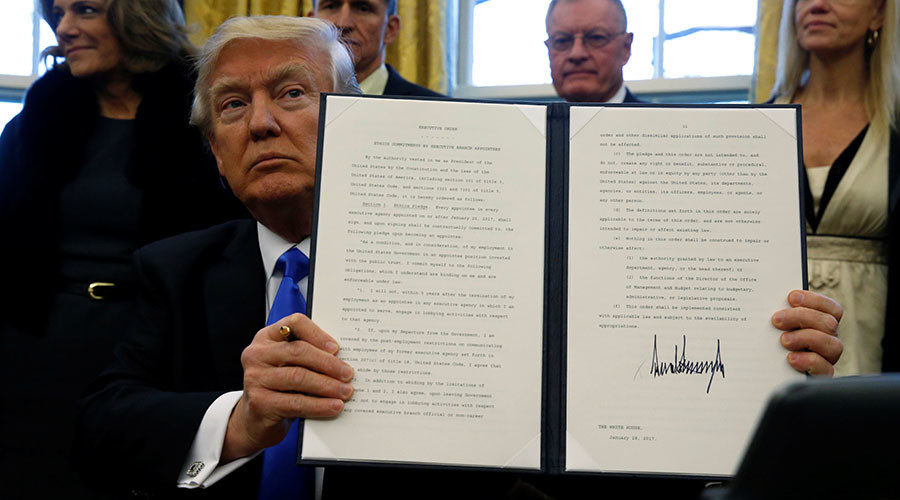 US President Donald Trump holds an executive order