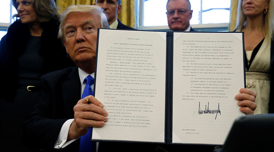 Click to enlarge US President Donald Trump holds an executive order