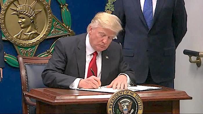 Click to enlarge Trump signing