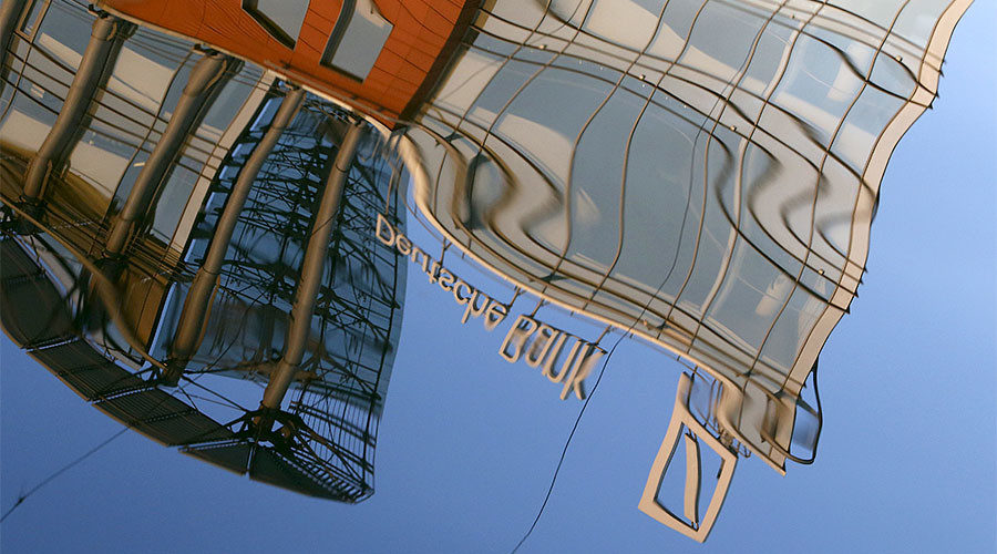 Click to enlarge logo of Deutsche Bank is reflected in the water