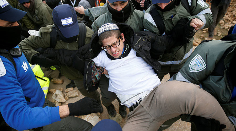 Israeli police remove a pro-settlement activist during an operation by Israeli forces to evict settlers from the illegal outpost of Amona in the occupied West Bank February 1, 2017