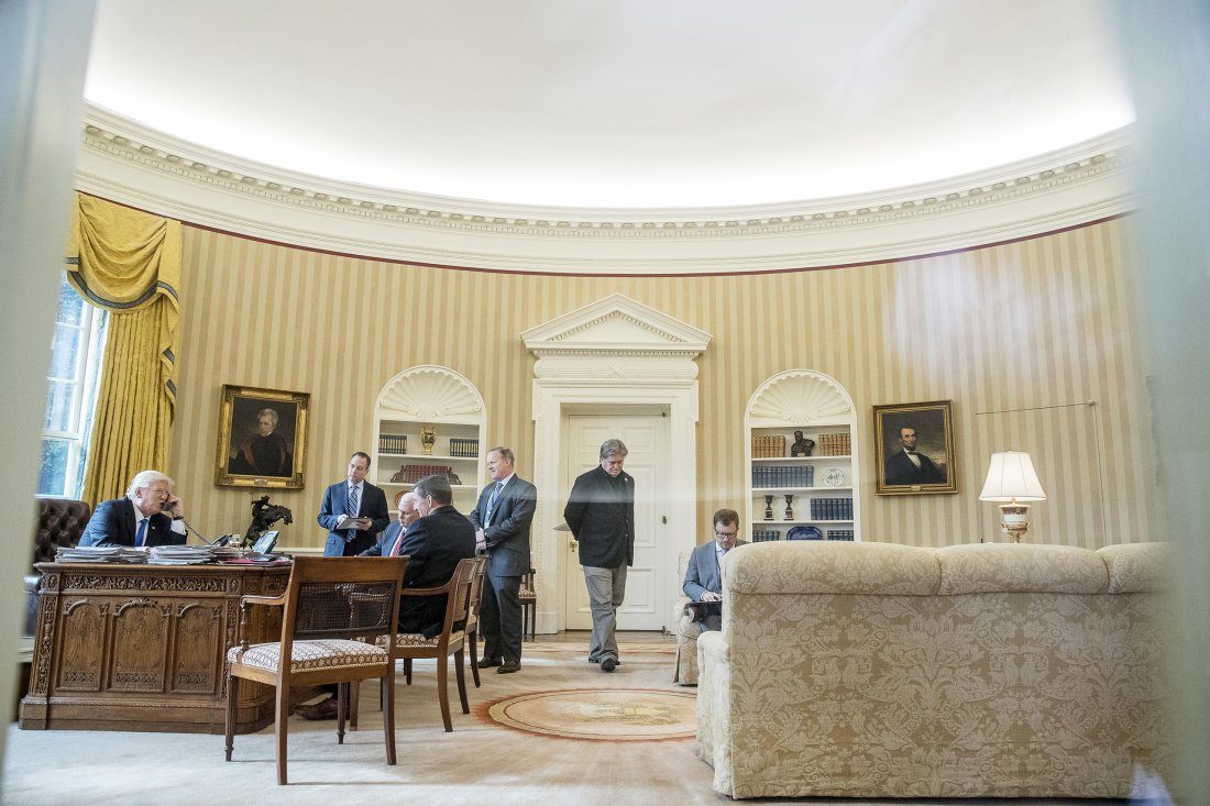 Bannon, second from right, paces the Oval Office Jan. 28 as President Trump speaks with Russian President Vladimir Putin
