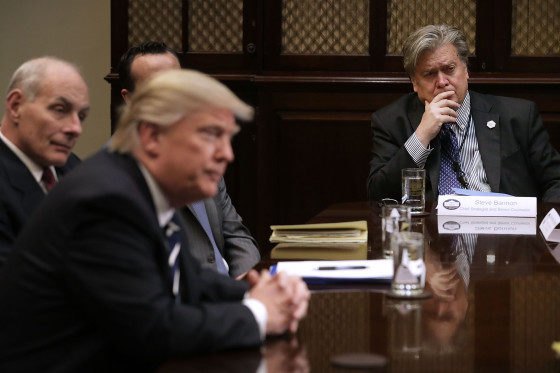 White House Chief Strategist Steve Bannon listens to President Donald Trump at the beginning of a meeting with government cyber security experts in the Roosevelt Room at the White House, on Jan. 31, 2017