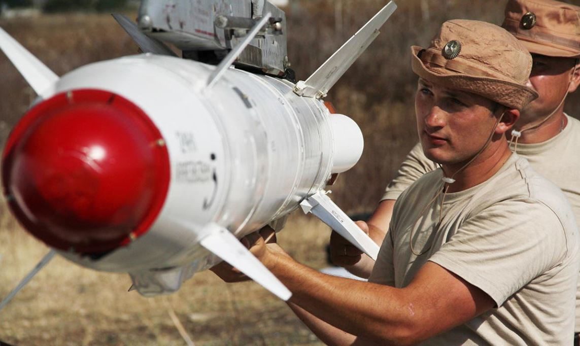 Russian soldiers loading bomb on jet