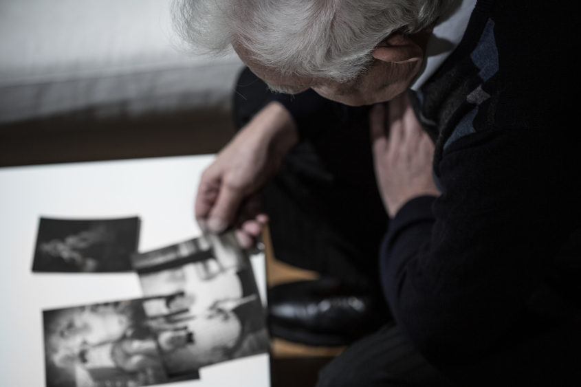 older man looking at pictures