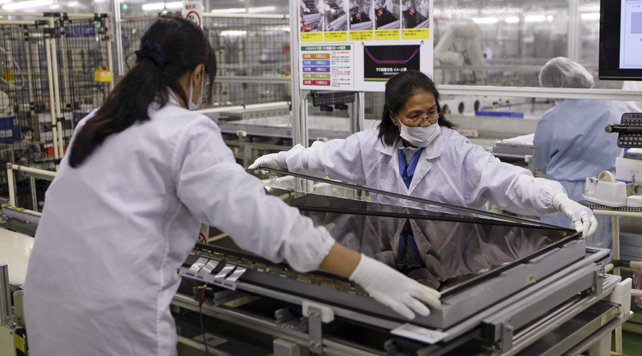 Women assemble a television in Tokyo