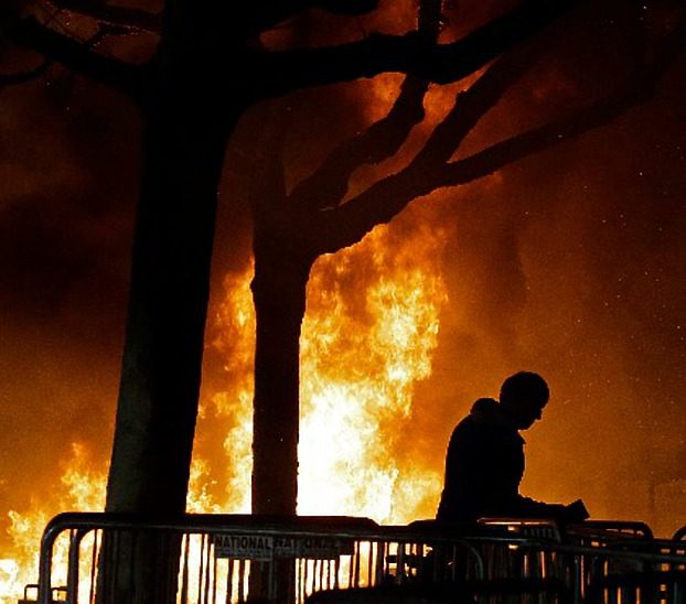 In this Feb. 1, 2017 file photo, a fire set by demonstrators protesting a scheduled speaking appearance by Breitbart News editor Milo Yiannopoulos burns on Sproul Plaza on the University of California, Berkeley campus