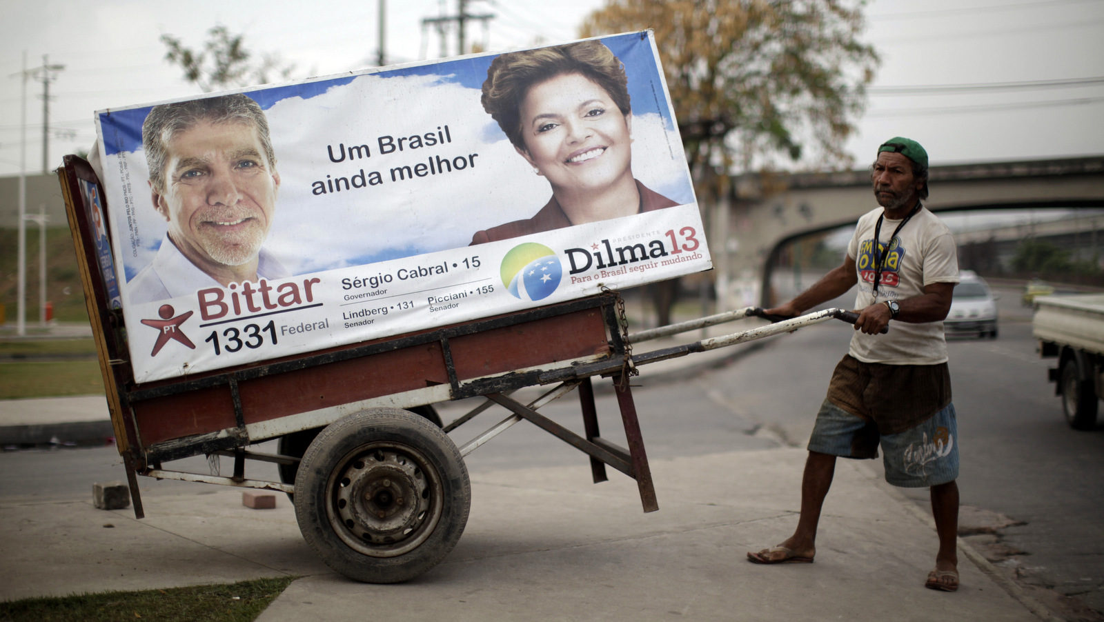 Click to enlarge man pulls a cart with an electoral poster of Workers Party presidential candidate Dilma Rousseff