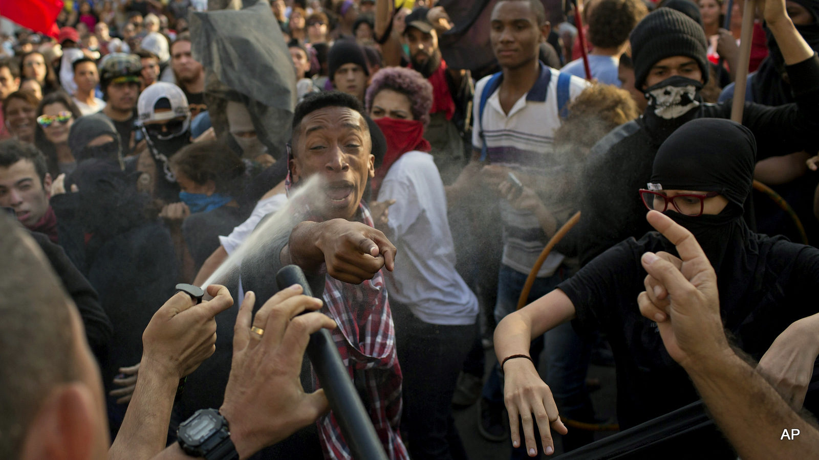 Brazil police officer pepper sprays demonstrators