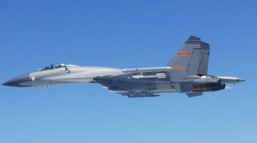 A Chinese SU-27 fighter flies over the East China Sea