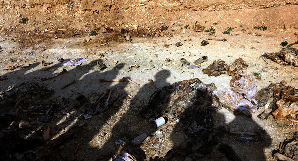 Members of Yazidi minority search for clues on February 3, 2015, that might lead them to missing relatives in the remains of people killed by the Islamic State (IS) jihadist group