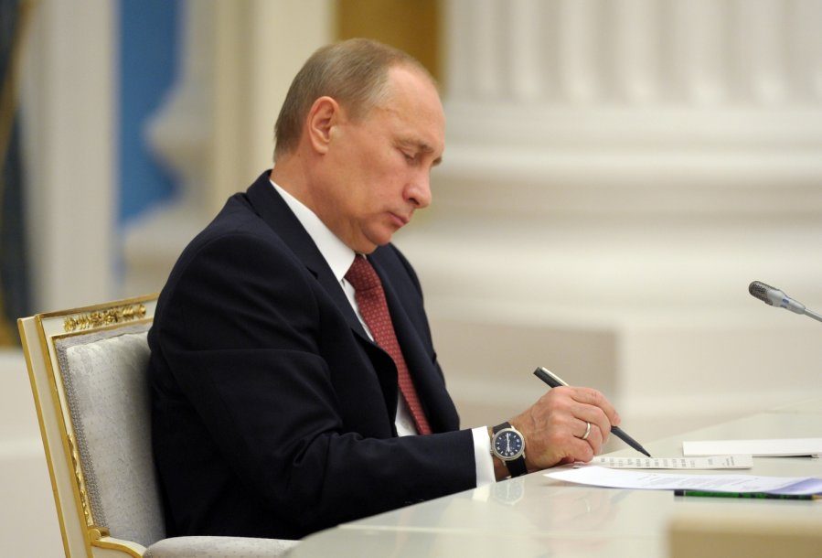 Click to enlarge Vladimir Putin signing document