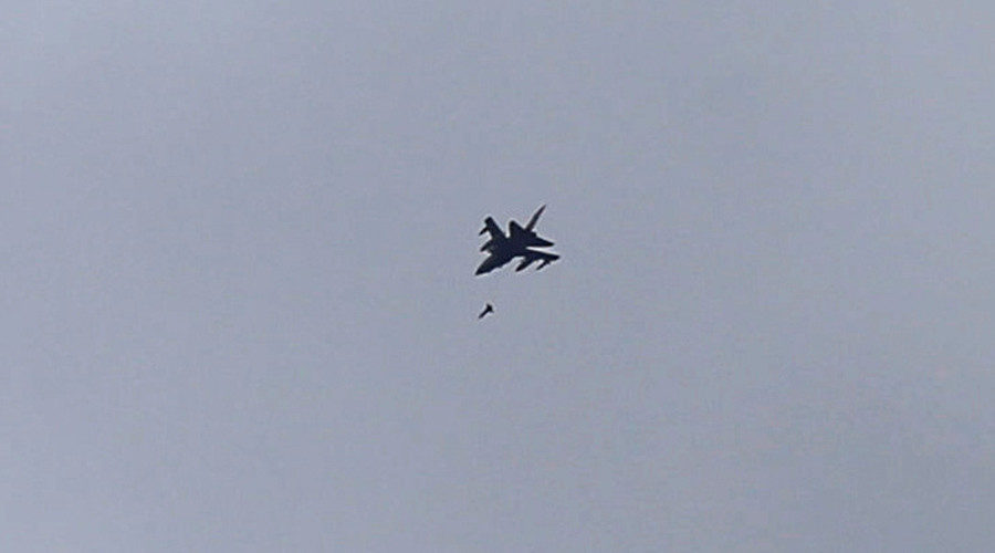 fighter jet belonging to the Saudi-led coalition fires a missile over Sanaa