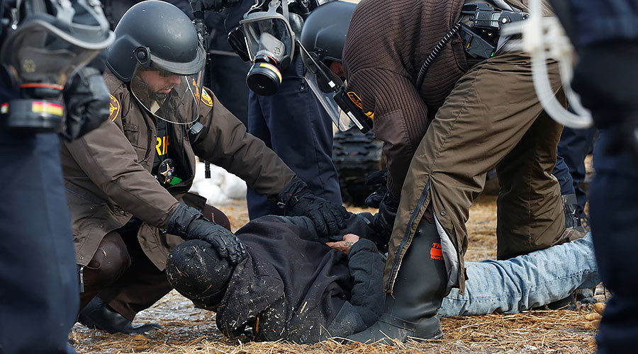 Police detain a protester against the Dakota Access oil pipeline, North Dakota, U.S., February 23, 2017
