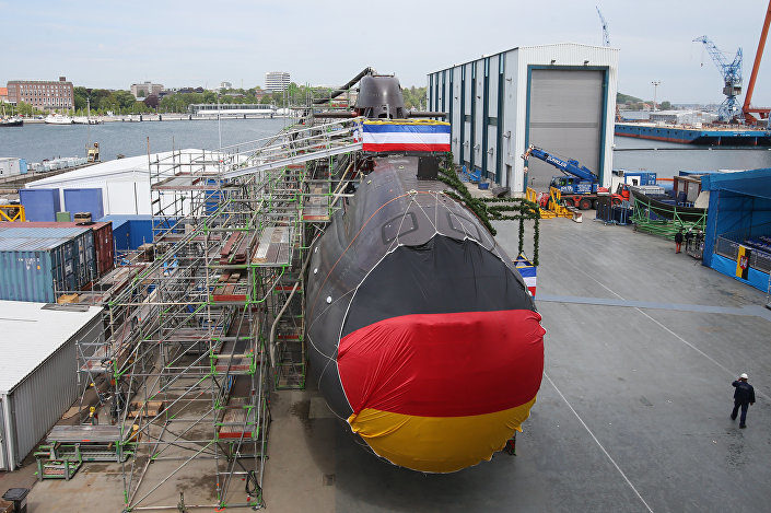 Shipyard workers and German soldiers attend the christening of the 