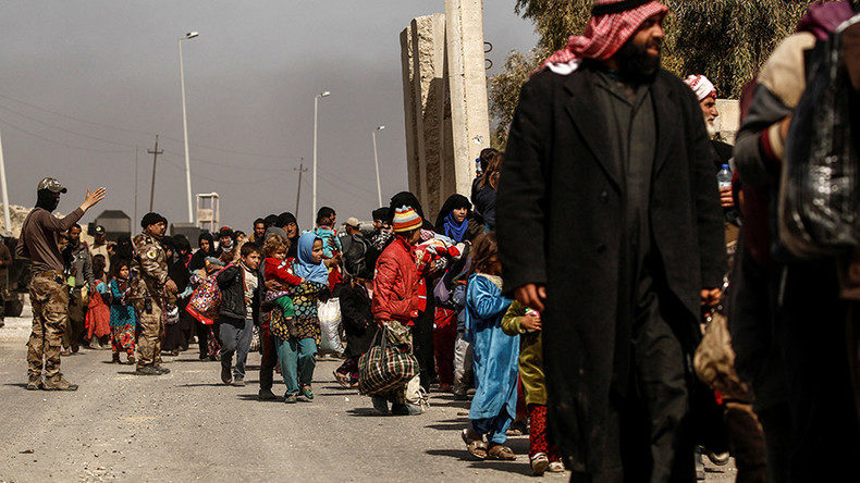 Displaced Iraqis flee their homes, while Iraqi forces battle with Islamic State militants in western Mosul