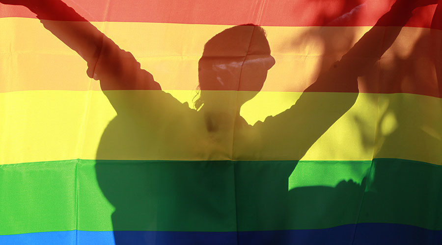 Person behind gay pride flag