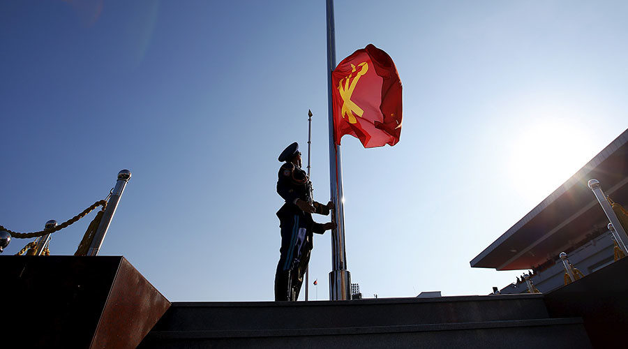 North Korean soldier lifts a flag