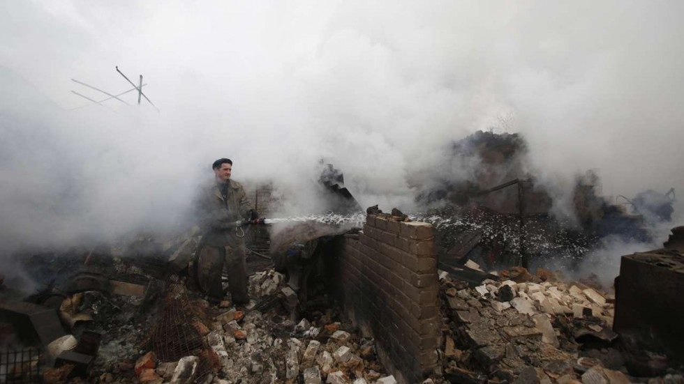 A firefighter douses a fire in Avdiivka, Ukraine