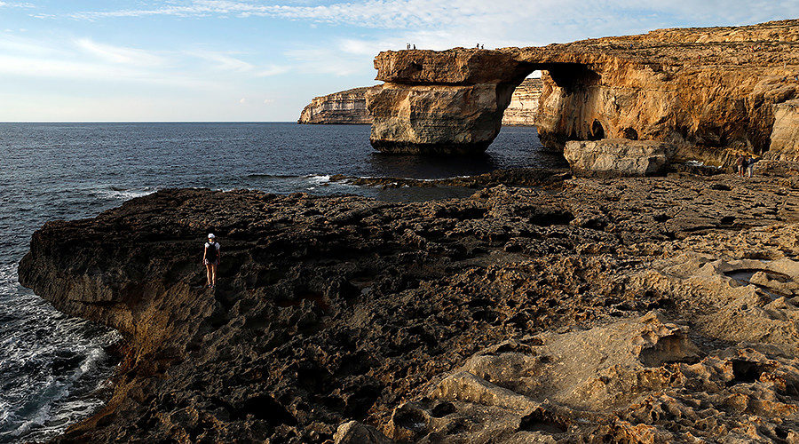 Tourists walk near the Azure Window