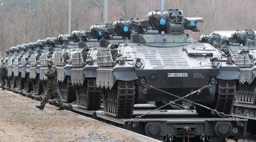German soldiers load armored vehicles 