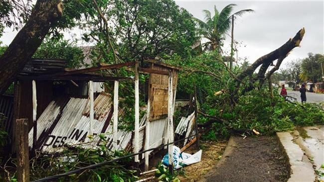 small building damaged by a tree in a street in Sambava, Madagascar, on March 8, 2017.
