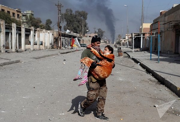 An Iraqi special forces soldier carries a woman injured during a battle between Iraqi forces and Islamic State fighters in Mosul