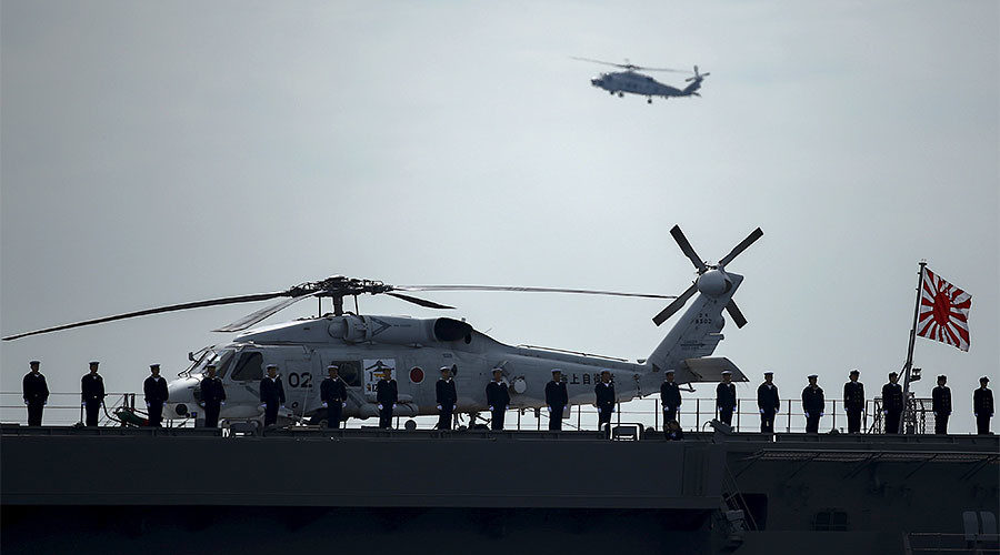Military personnel stand on deck of the Izumo helicopter carrier