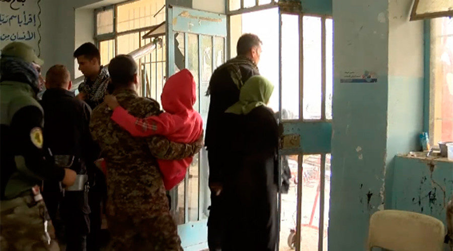 Click to enlarge Mosul family flees airstrike