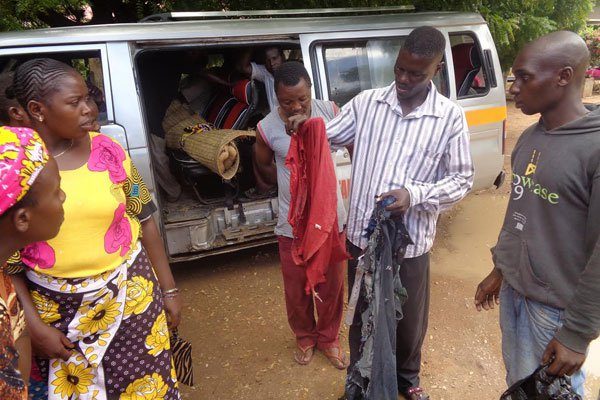 Click to enlarge A resident of Gongoni in Kilifi County displays the clothes Musa Kenga Karisa was wearing when he was struck and killed by lightning on March 18, 2017.
