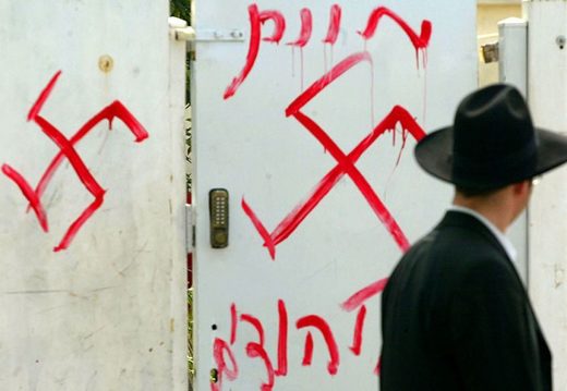 Hasidm walking past swastikas