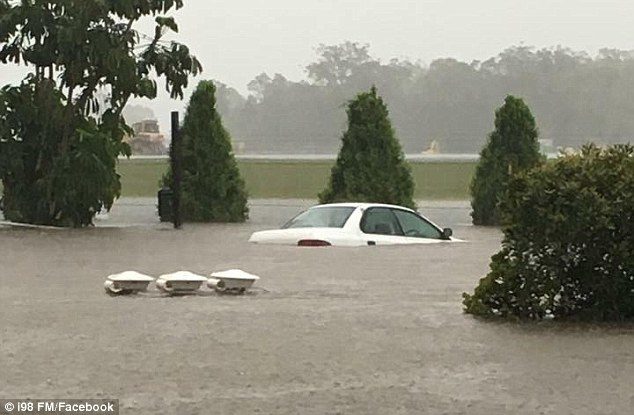 Ten staff and four students had to be rescued from a school in Shellharbour yesterday after it was flooded while a school bus got stranded in Albion Park 